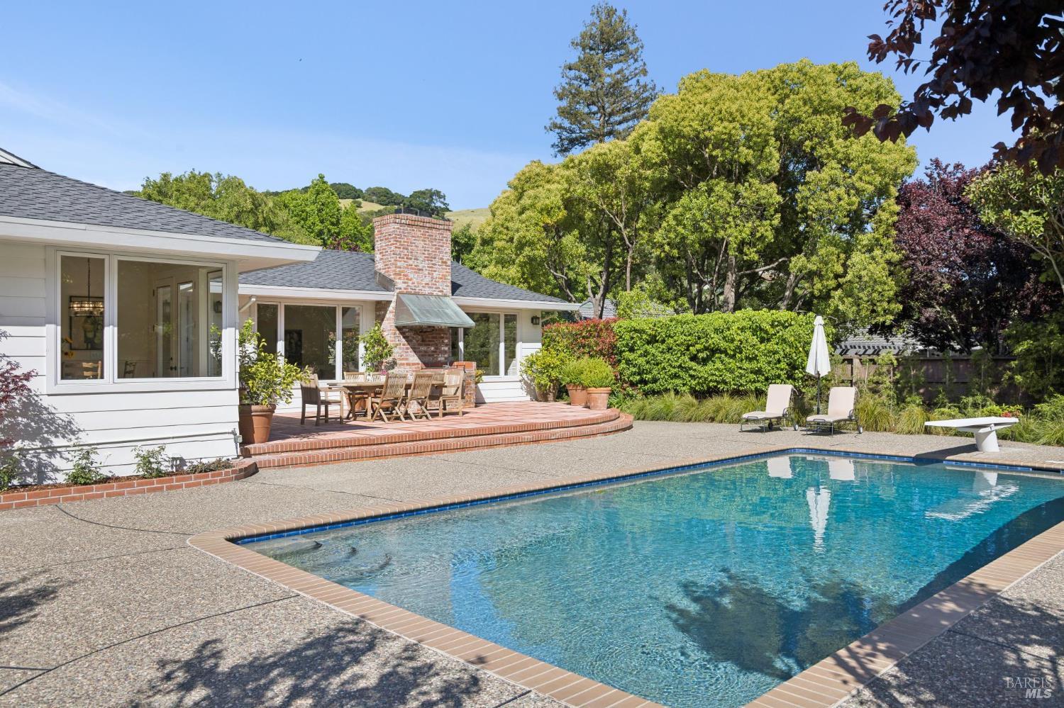 1199 Butterfield Road San Anselmo, CA 94960 - Photo 53 of 65 a view of a swimming pool with two chairs in patio