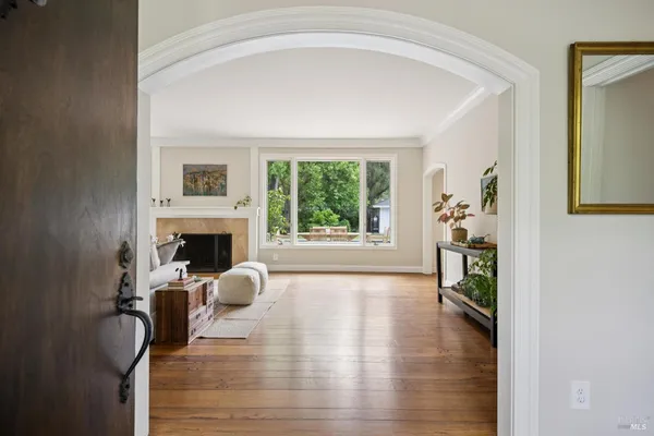 a living room with fireplace furniture and a large window
