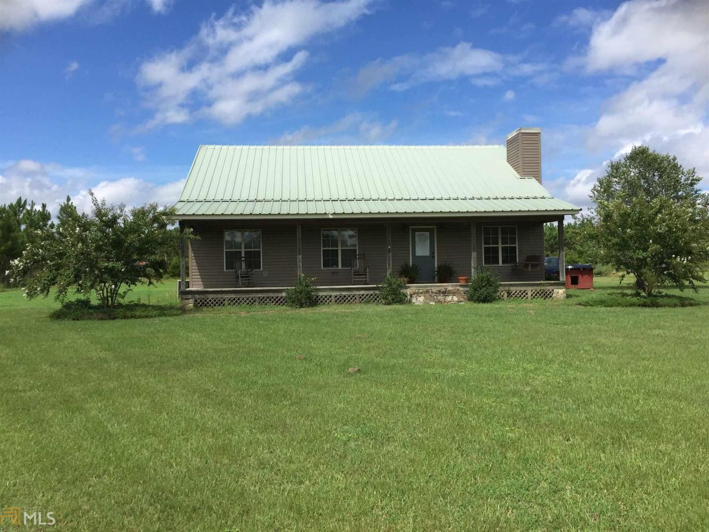 12536 Watson Road Metter, GA 30439 - Photo 1 of 1 a front view of a house with a garden