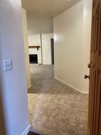 a view of empty room with a fireplace