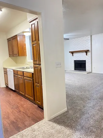 a view of a kitchen with a sink and a fireplace