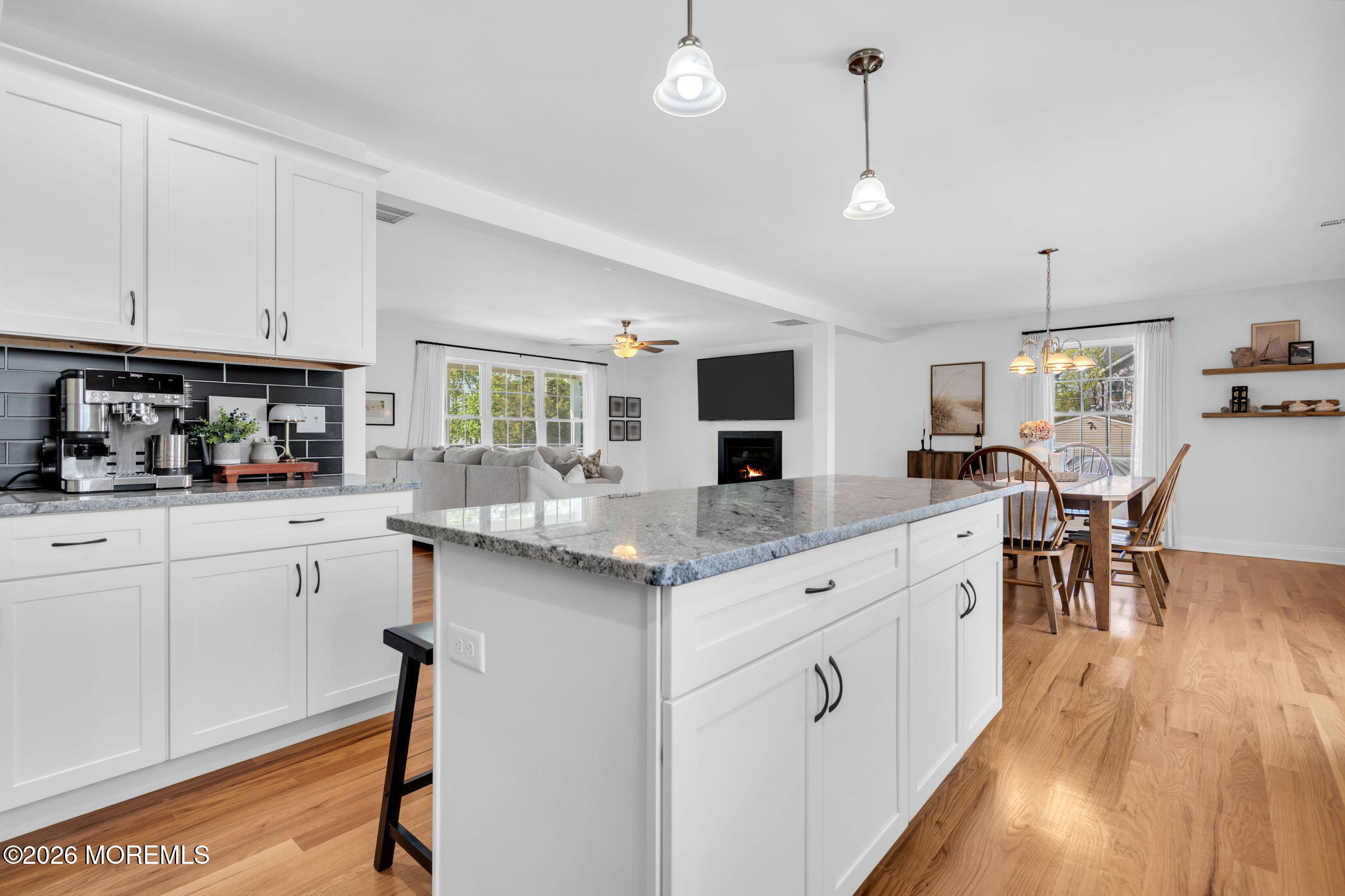 312 Beach Boulevard Forked River, NJ 08731 - Photo 23 of 40 a kitchen with granite countertop white cabinets and chairs