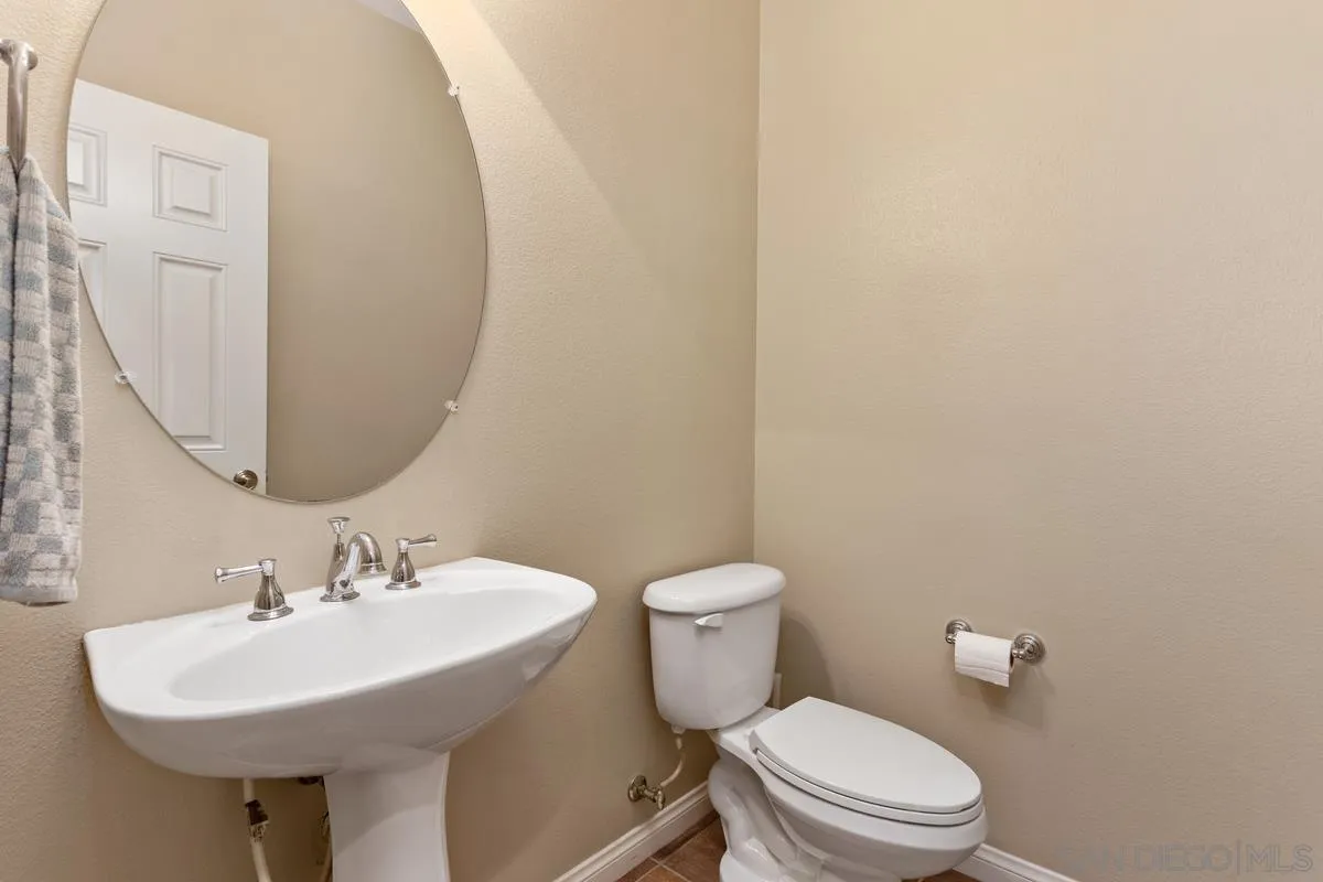 1175 Tee Street Oceanside, CA 92057 - Photo 10 of 26 a white toilet sitting next to a bathroom sink