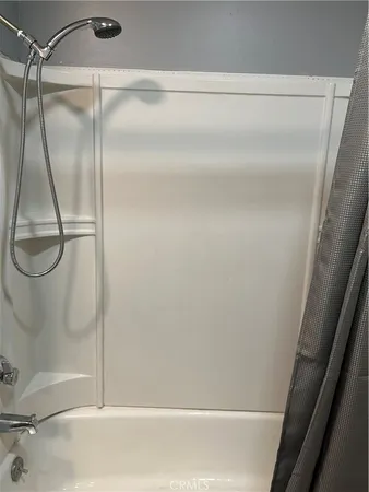 a bathroom with a glass shower door
