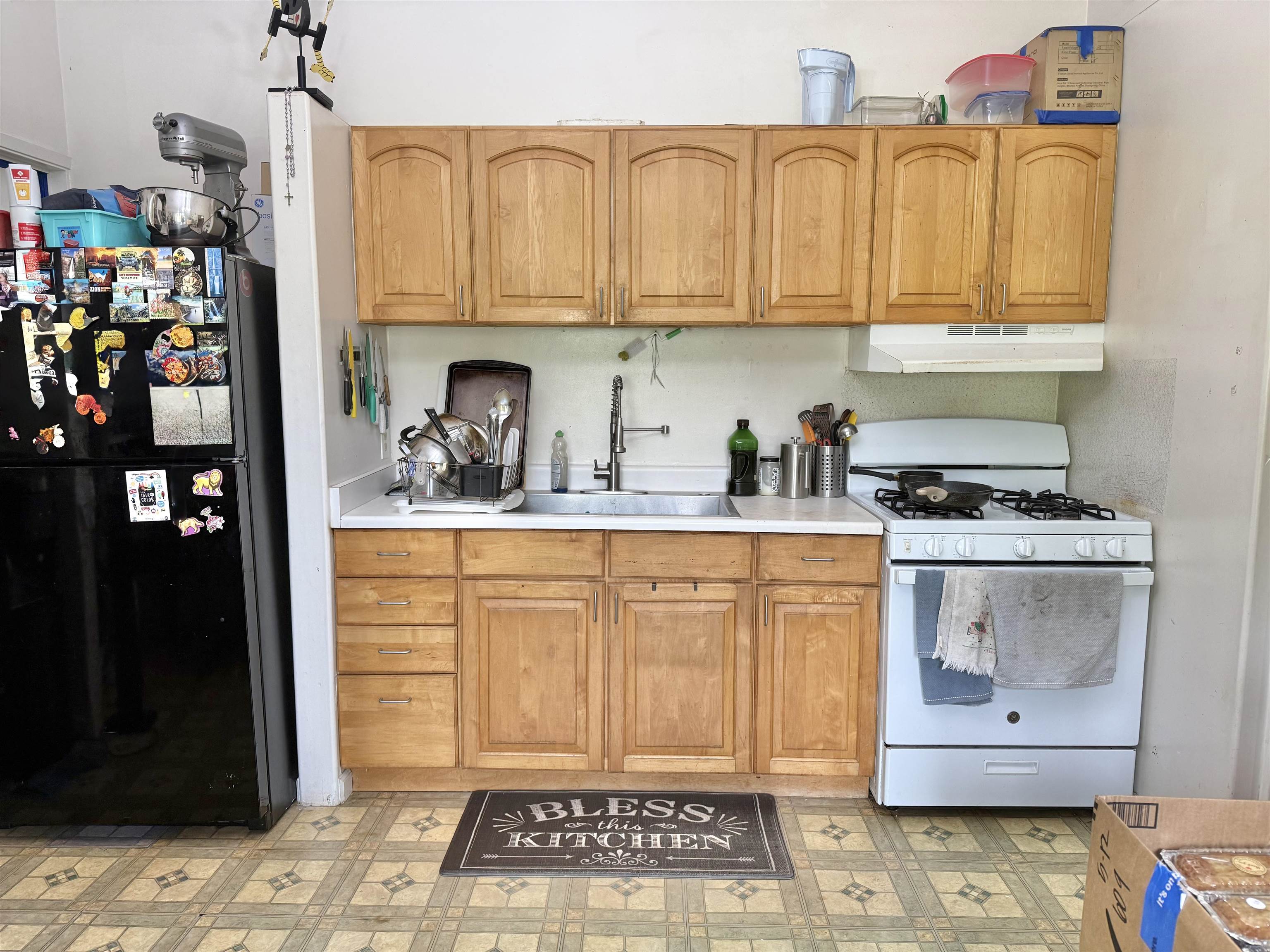 1630 Kauhikoa Road Haiku, HI 96708 - Photo 33 of 48 a kitchen with stainless steel appliances granite countertop a refrigerator and sink