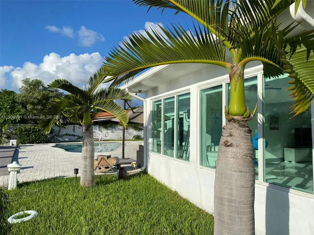 a view of a house with a backyard