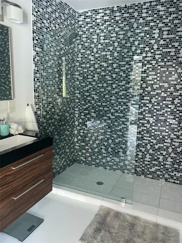 a bathroom with a bathtub and shower