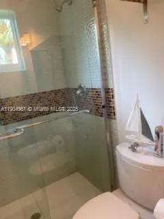 a bathroom with a granite countertop sink a toilet and bathtub