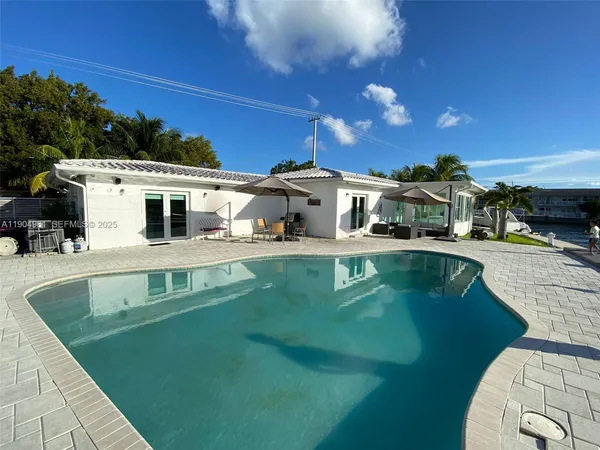 a view of a patio with swimming pool table and chairs