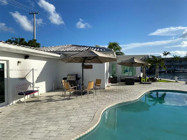 a view of a patio with swimming pool table and chairs