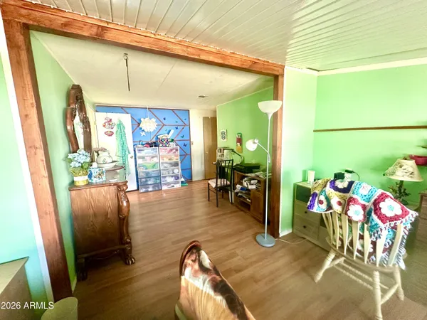a view of a dining room with furniture one side kitchen view