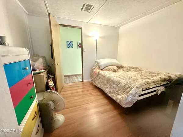 a bedroom with a bed and a mirror