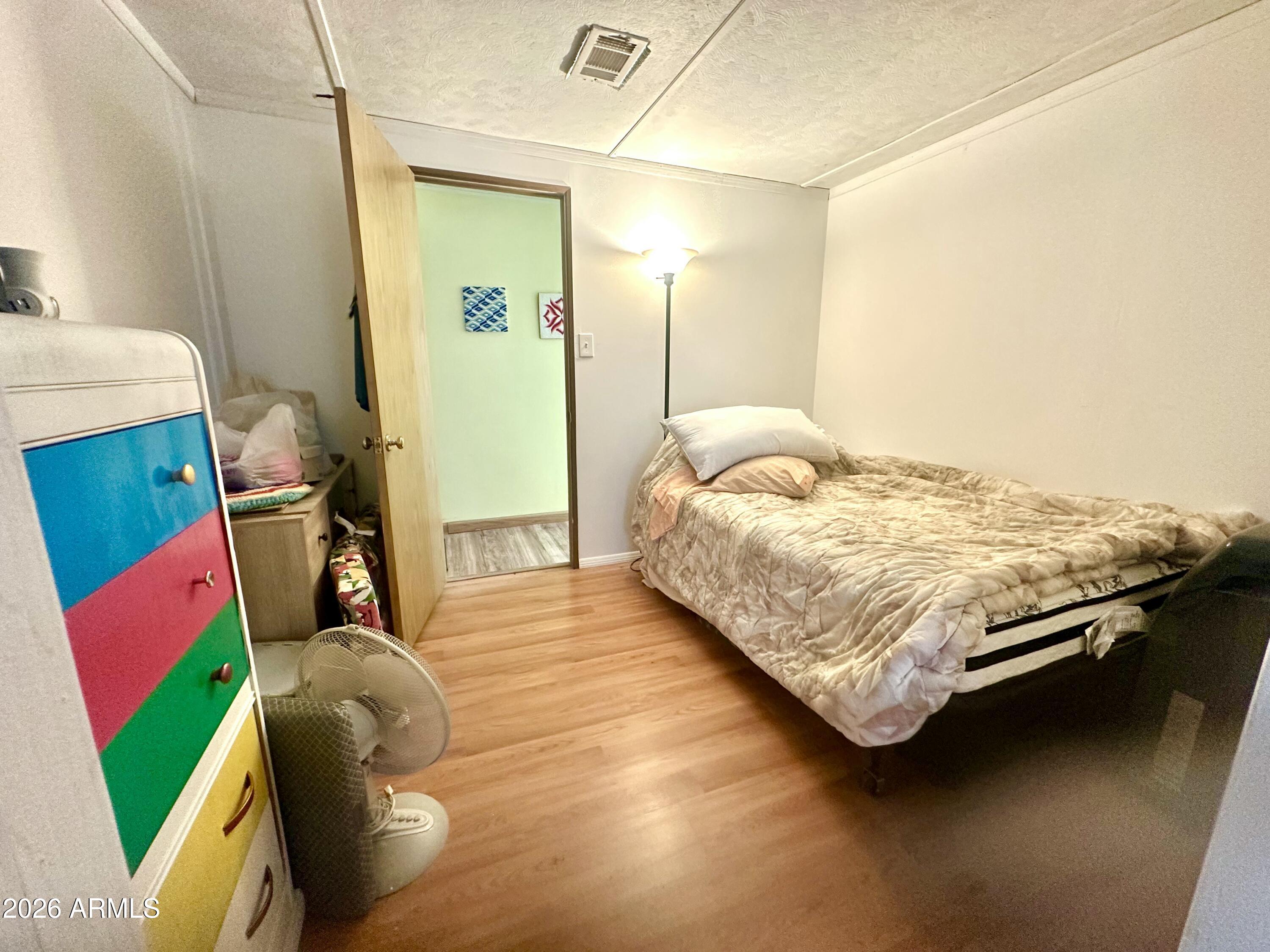 17412 East Trails End Road Mayer, AZ 86333 - Photo 18 of 28 a bedroom with a bed and a mirror