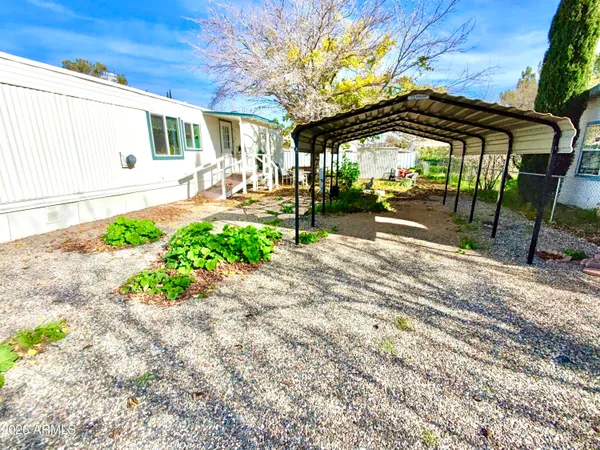 a view of a patio with a table and chairs under an umbrella