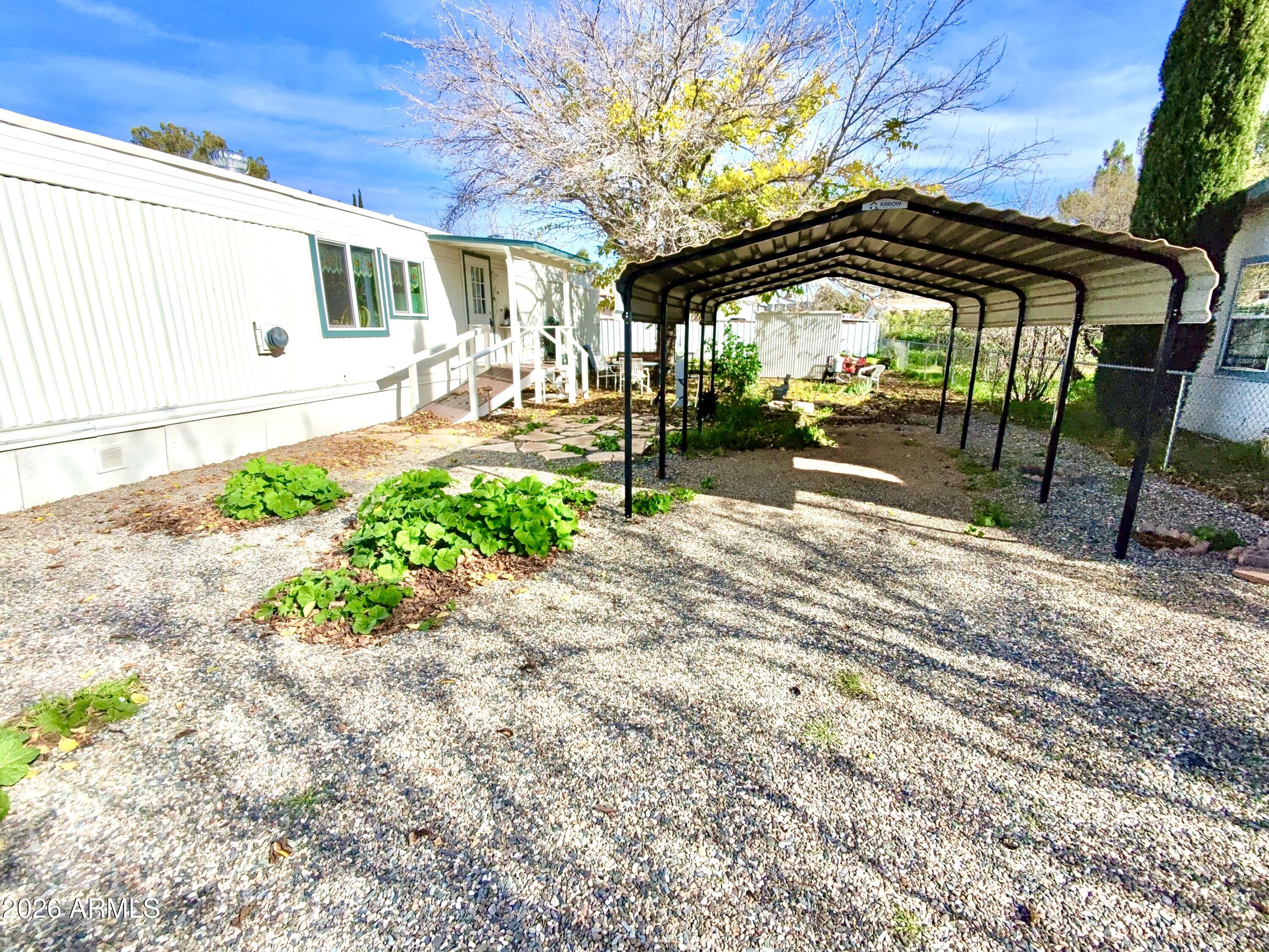 17412 East Trails End Road Mayer, AZ 86333 - Photo 5 of 28 a view of a patio with a table and chairs under an umbrella