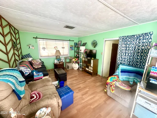 a living room with furniture and a wooden floor