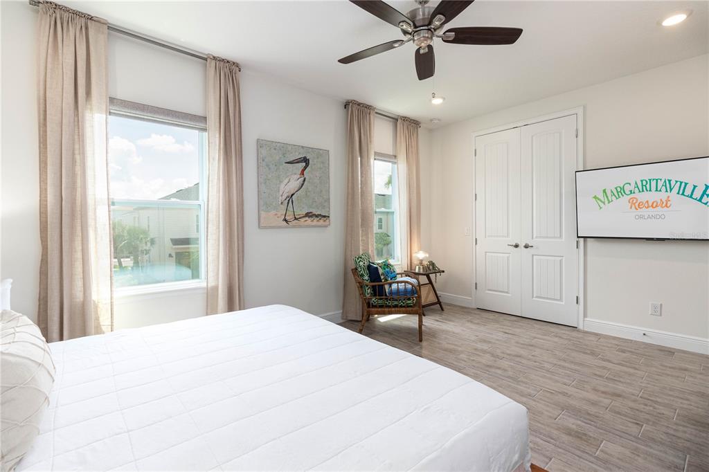 2960 On The Rocks Point Kissimmee, FL 34747 - Photo 12 of 17 a bedroom with a large bed and a chandelier