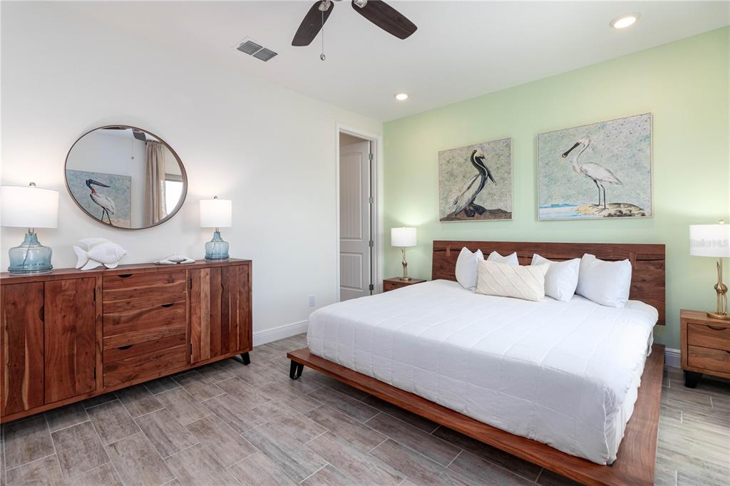 2960 On The Rocks Point Kissimmee, FL 34747 - Photo 14 of 17 a bedroom with a bed and wooden floor