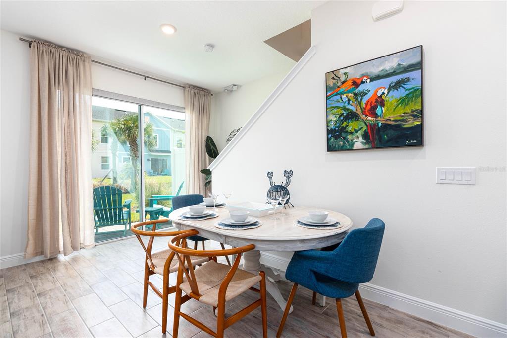 2960 On The Rocks Point Kissimmee, FL 34747 - Photo 7 of 17 a view of a dining room with furniture a rug and a painting on the wall