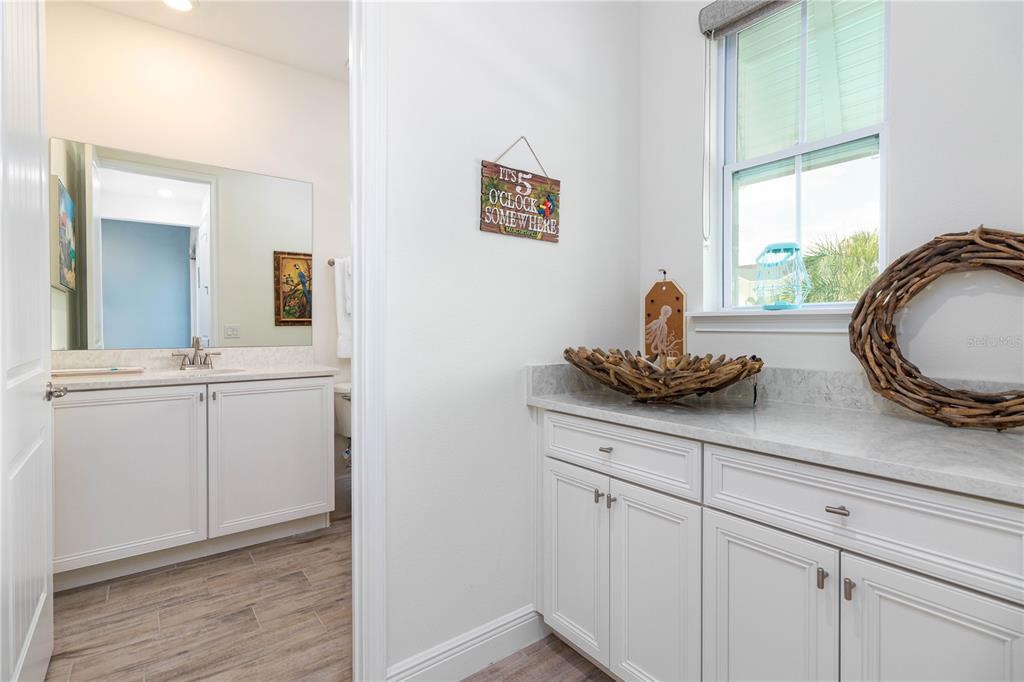 2960 On The Rocks Point Kissimmee, FL 34747 - Photo 8 of 17 a bathroom with a granite countertop sink a mirror and vanity