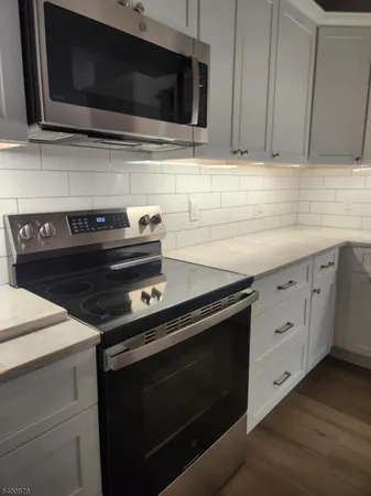 a kitchen with microwave stove and cabinets