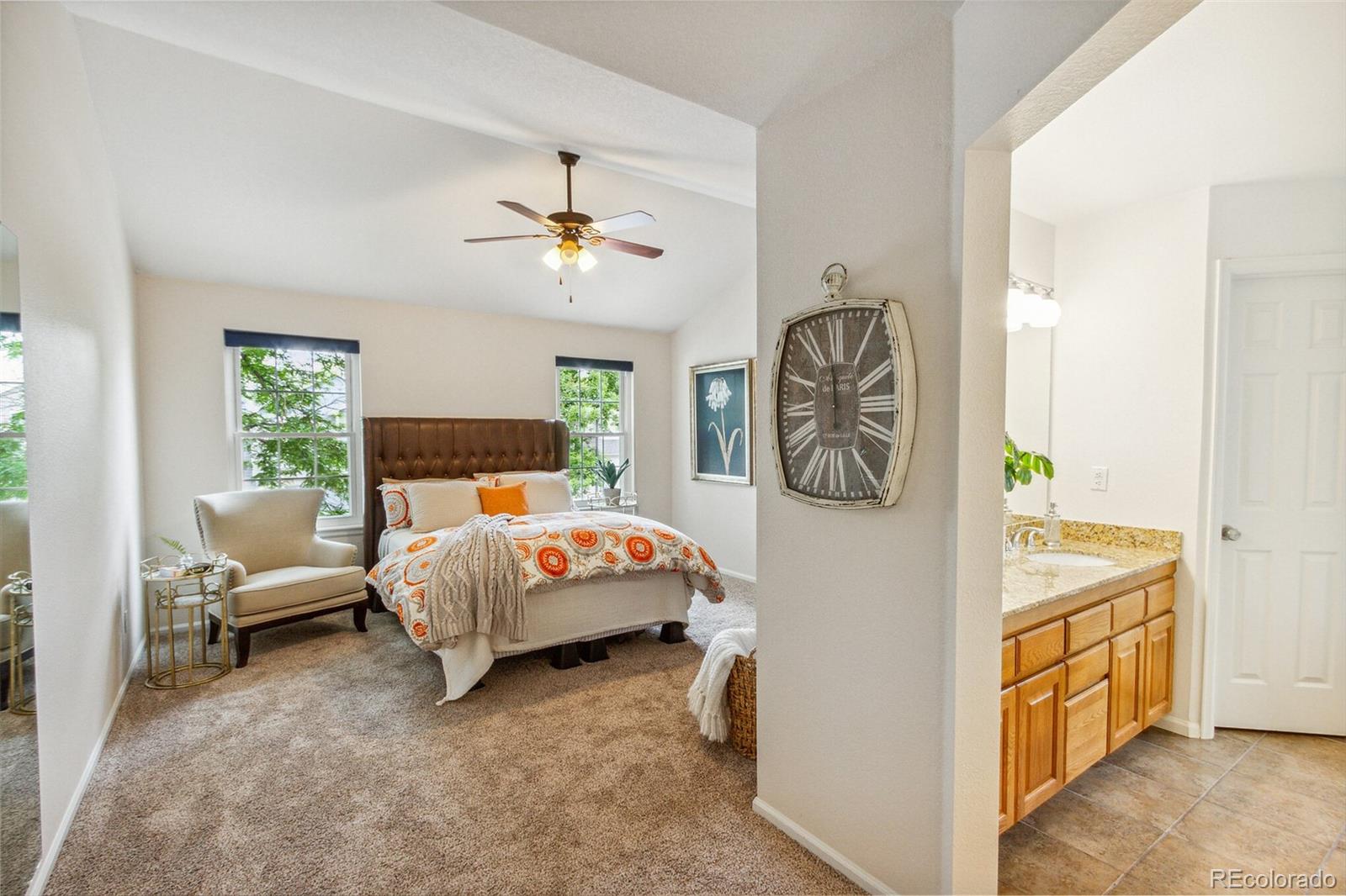 2975 East 133rd Circle Thornton, CO 80241 - Photo 18 of 29 a spacious bedroom with a bed and a chandelier