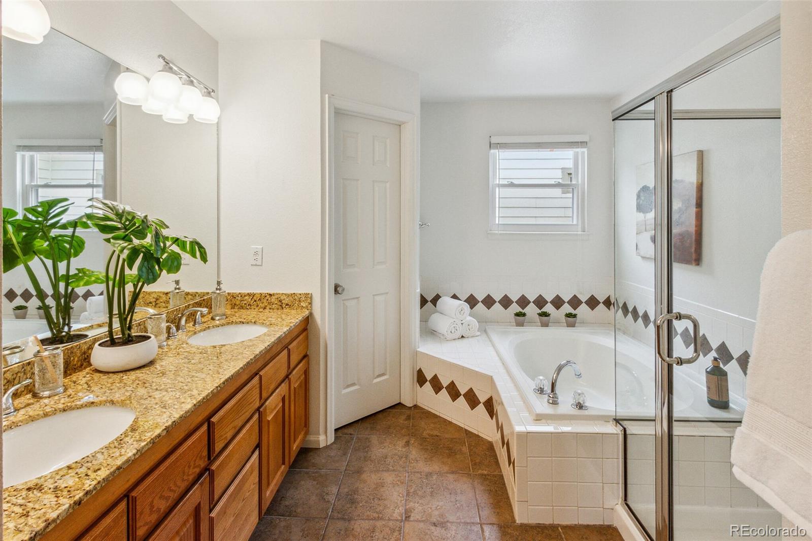 2975 East 133rd Circle Thornton, CO 80241 - Photo 21 of 29 a bathroom with tub sink and mirror