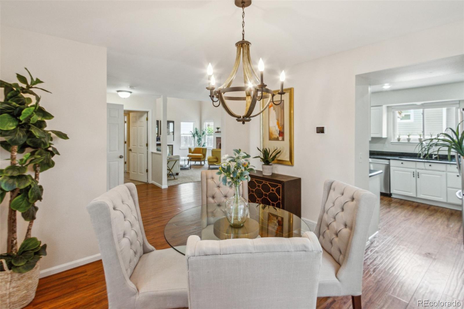 2975 East 133rd Circle Thornton, CO 80241 - Photo 7 of 29 a dining room with furniture a chandelier and wooden floor