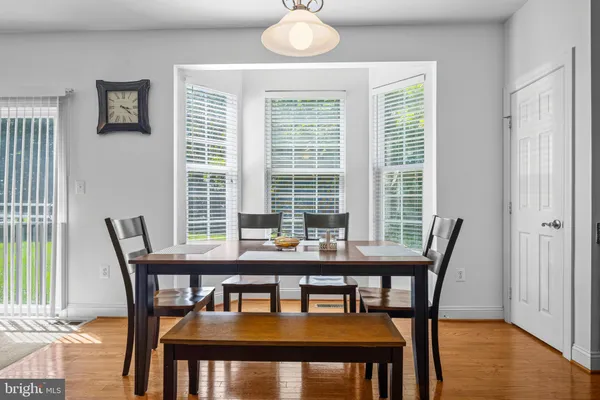 a dining room with furniture wooden floor and a chandelier