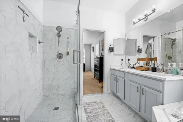 a bathroom with a shower sink and a mirror