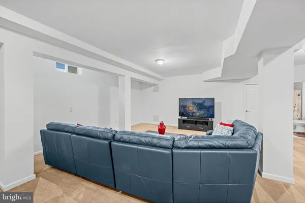a living room with furniture and potted plant