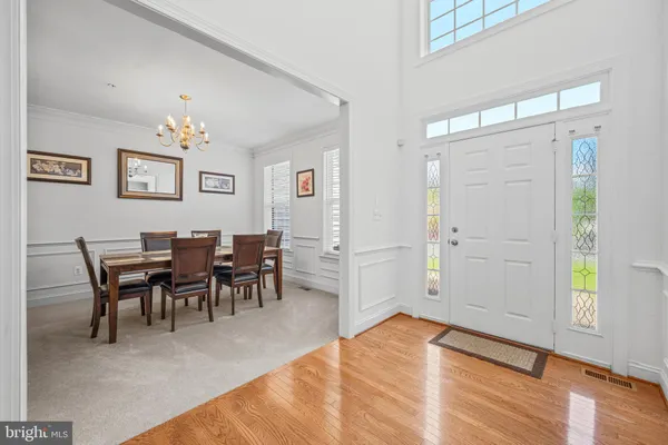 a view of a dining room with furniture and chandelier