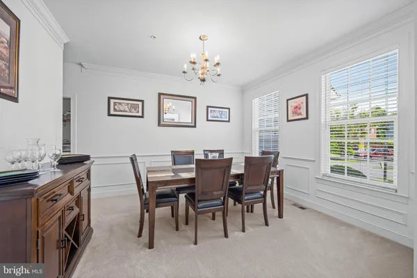 a view of a dining room with furniture and a chandelier
