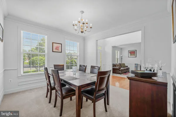 a view of a dining room with furniture and chandelier