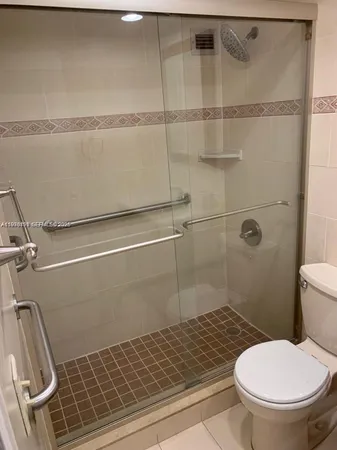 a bathroom with a toilet and a shower