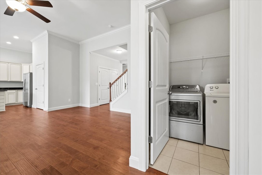 102 Ripplestone Way Anderson, SC 29621 - Photo 6 of 39 Well-lit interior space with rich hardwood floors leading to a convenient laundry area.
