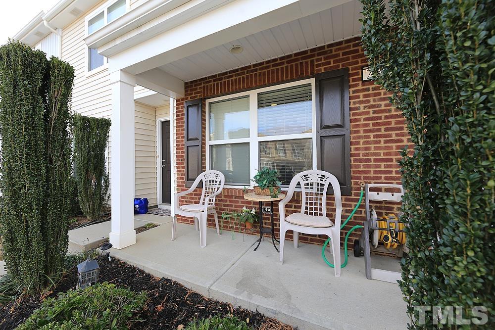 2927 Berkeley Springs Place Raleigh, NC 27616 - Photo 2 of 14 a balcony with table and chairs and potted plants