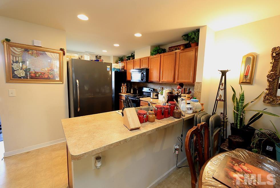 2927 Berkeley Springs Place Raleigh, NC 27616 - Photo 3 of 14 a kitchen with stainless steel appliances a refrigerator and a stove