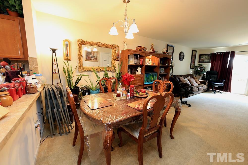2927 Berkeley Springs Place Raleigh, NC 27616 - Photo 5 of 14 a view of a dining room with furniture and chandelier