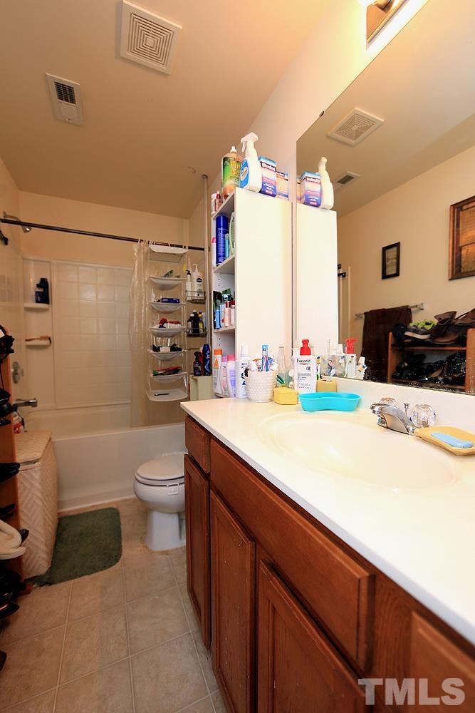 2927 Berkeley Springs Place Raleigh, NC 27616 - Photo 8 of 14 a bathroom with a sink a toilet and shower