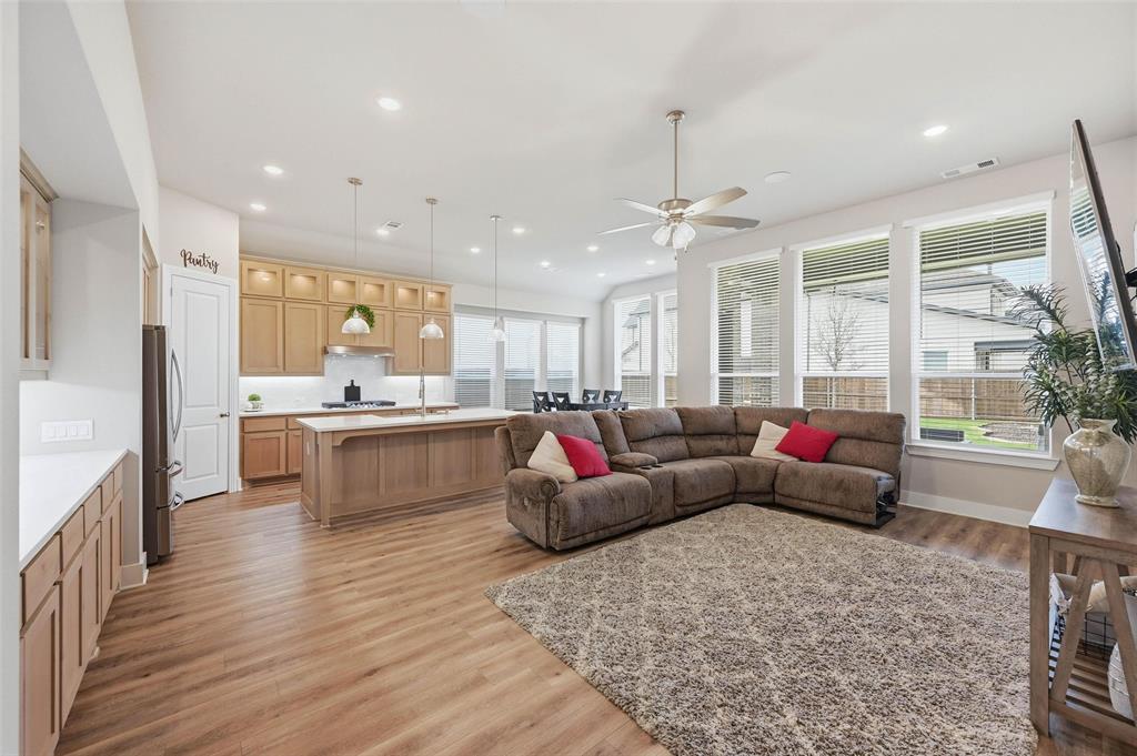 1205 Roundwash Way Midlothian, TX 76065 - Photo 6 of 38 a living room with kitchen island furniture and a chandelier