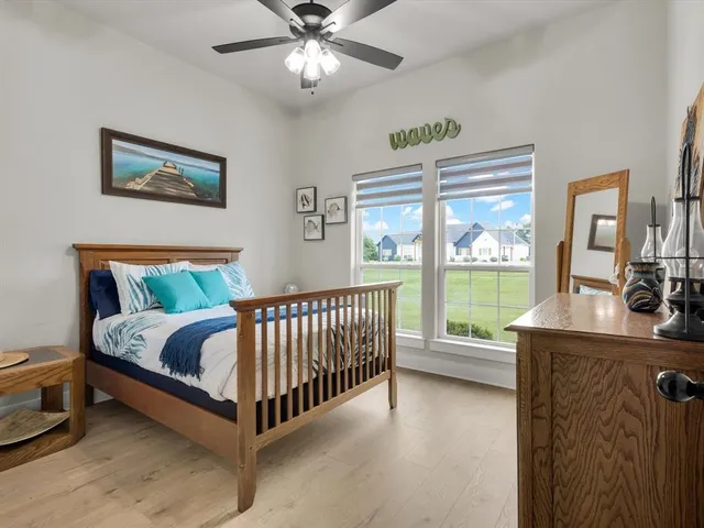 a bedroom with a bed and a large window