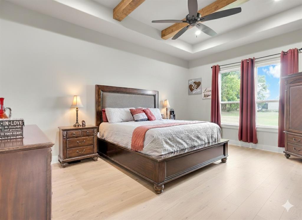 650 Winkler Way Springtown, TX 76082 - Photo 16 of 27 a large bed sitting in a room next to a lamp