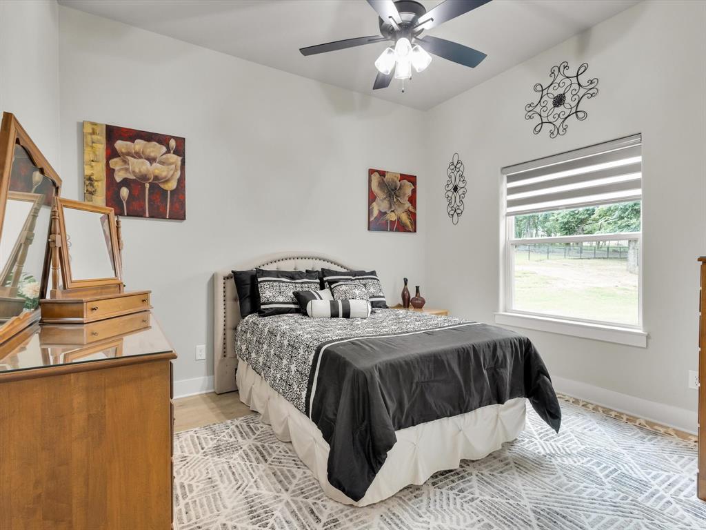 650 Winkler Way Springtown, TX 76082 - Photo 17 of 30 a bedroom with a large bed and a window