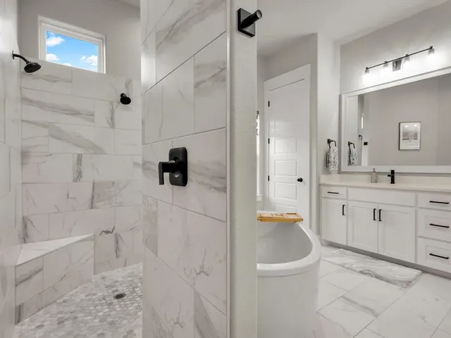 a bathroom with a granite countertop sink a toilet and shower