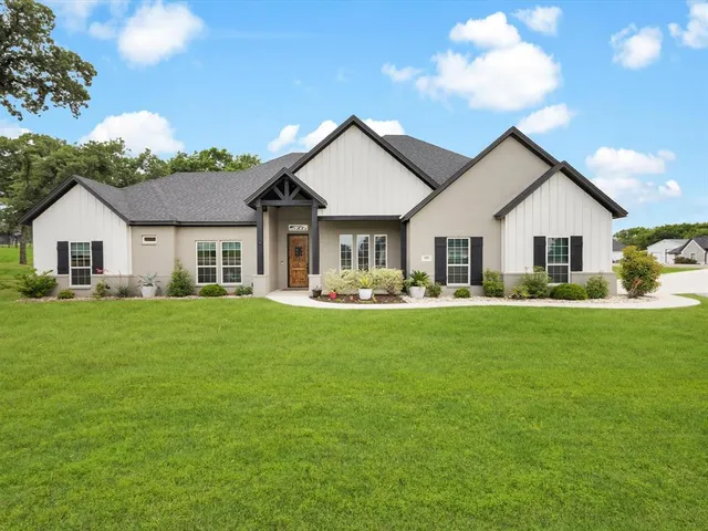 a front view of house with yard and green space