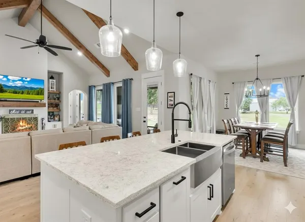 a kitchen with stainless steel appliances granite countertop a stove a sink and a refrigerator