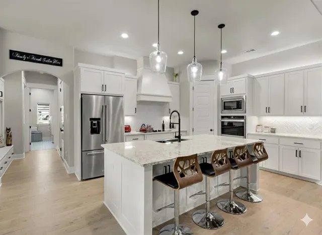 a large kitchen with a table and chairs