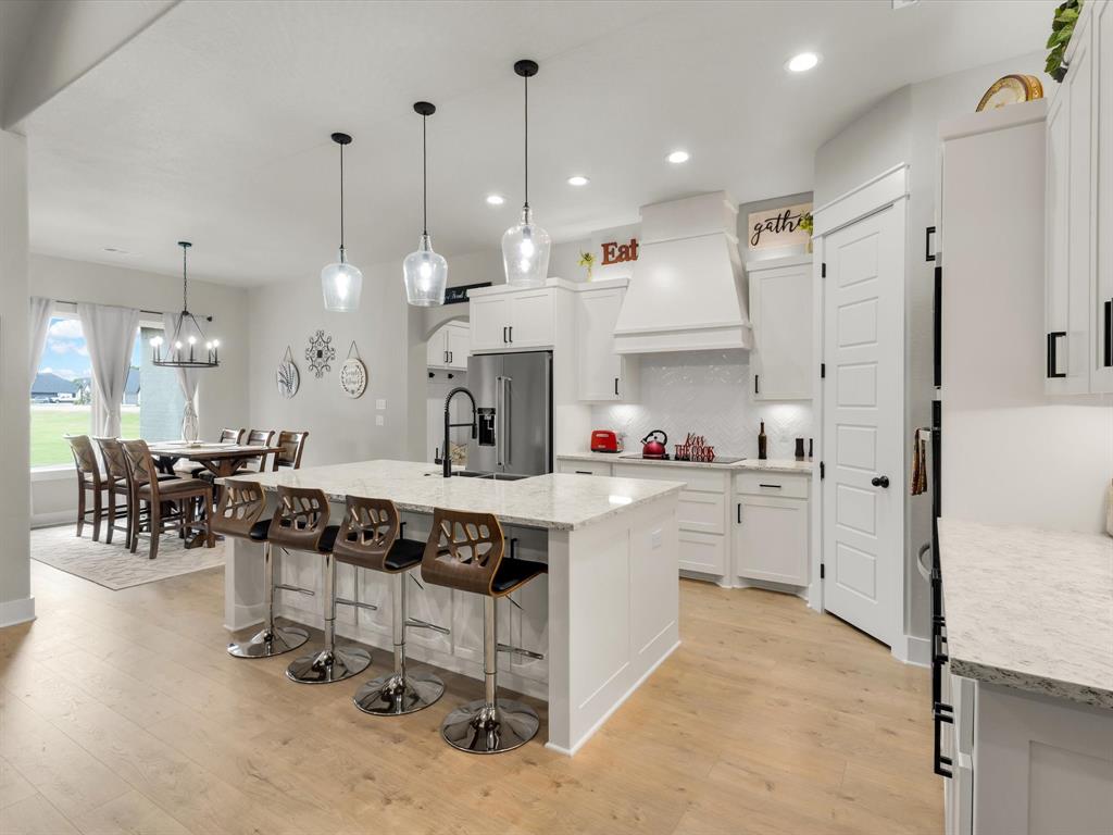 650 Winkler Way Springtown, TX 76082 - Photo 10 of 27 a large white kitchen with lots of counter space and stainless steel appliances