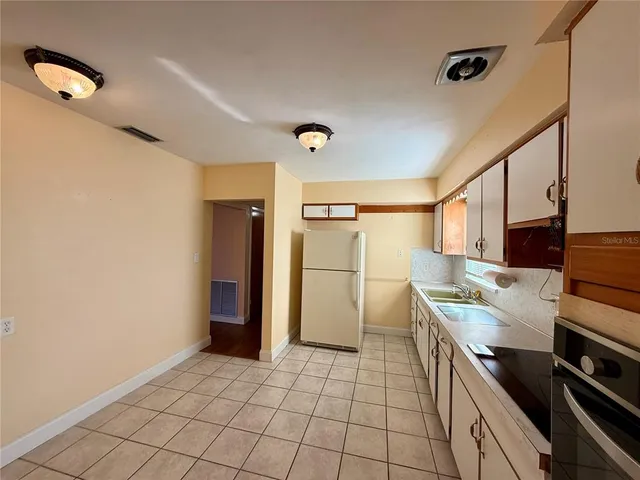 a kitchen that has a sink and a stove